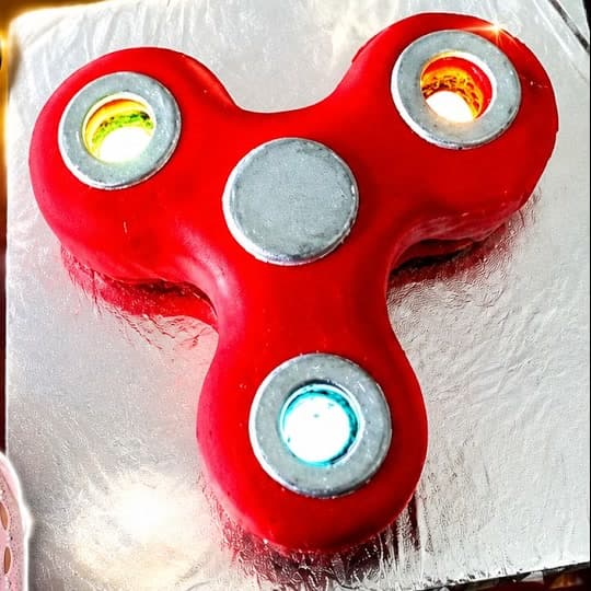Red fidget spinner shaped 3D cake that actually spins, custom novelty cake